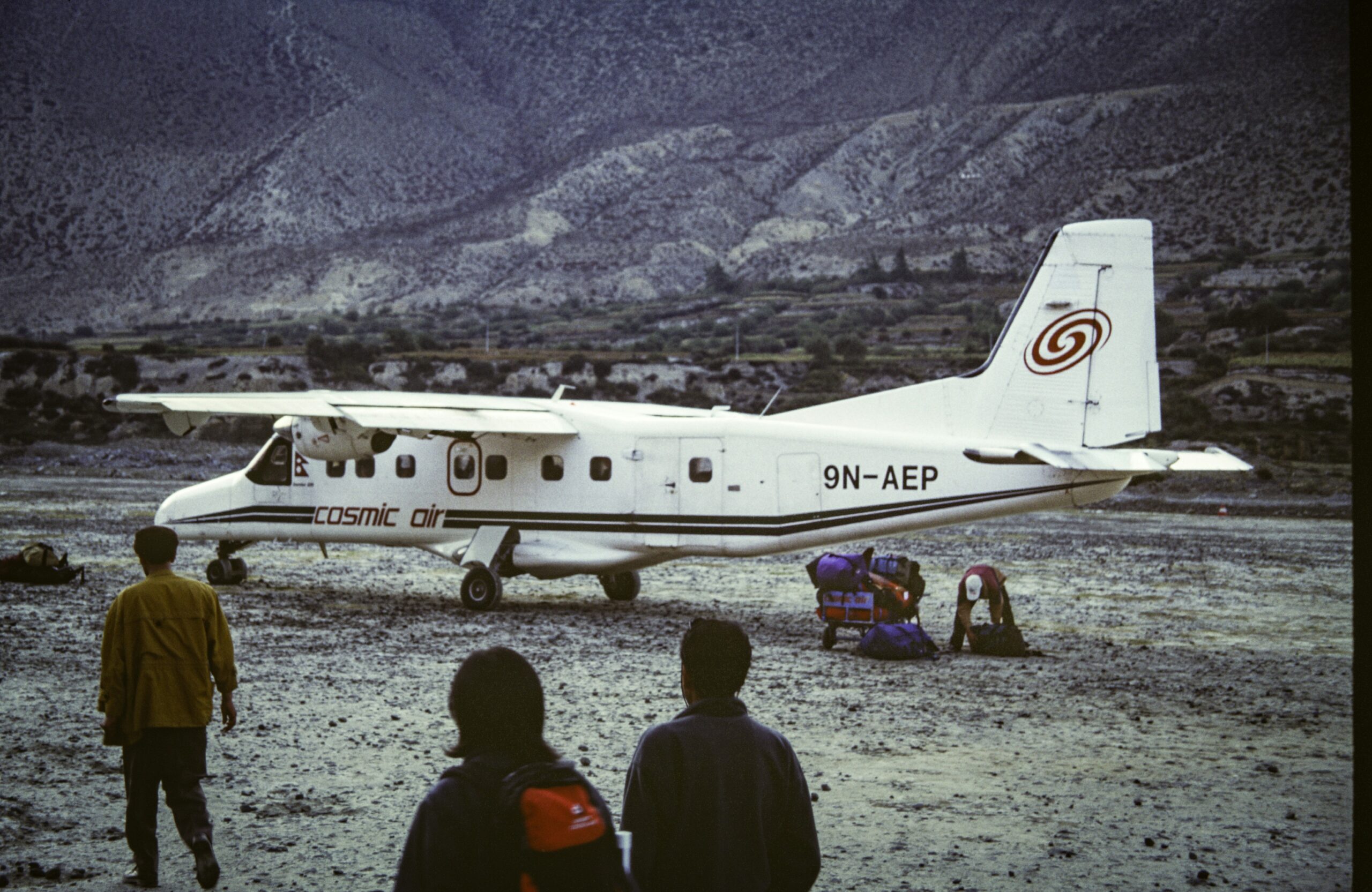 A group of people standing around a small plane