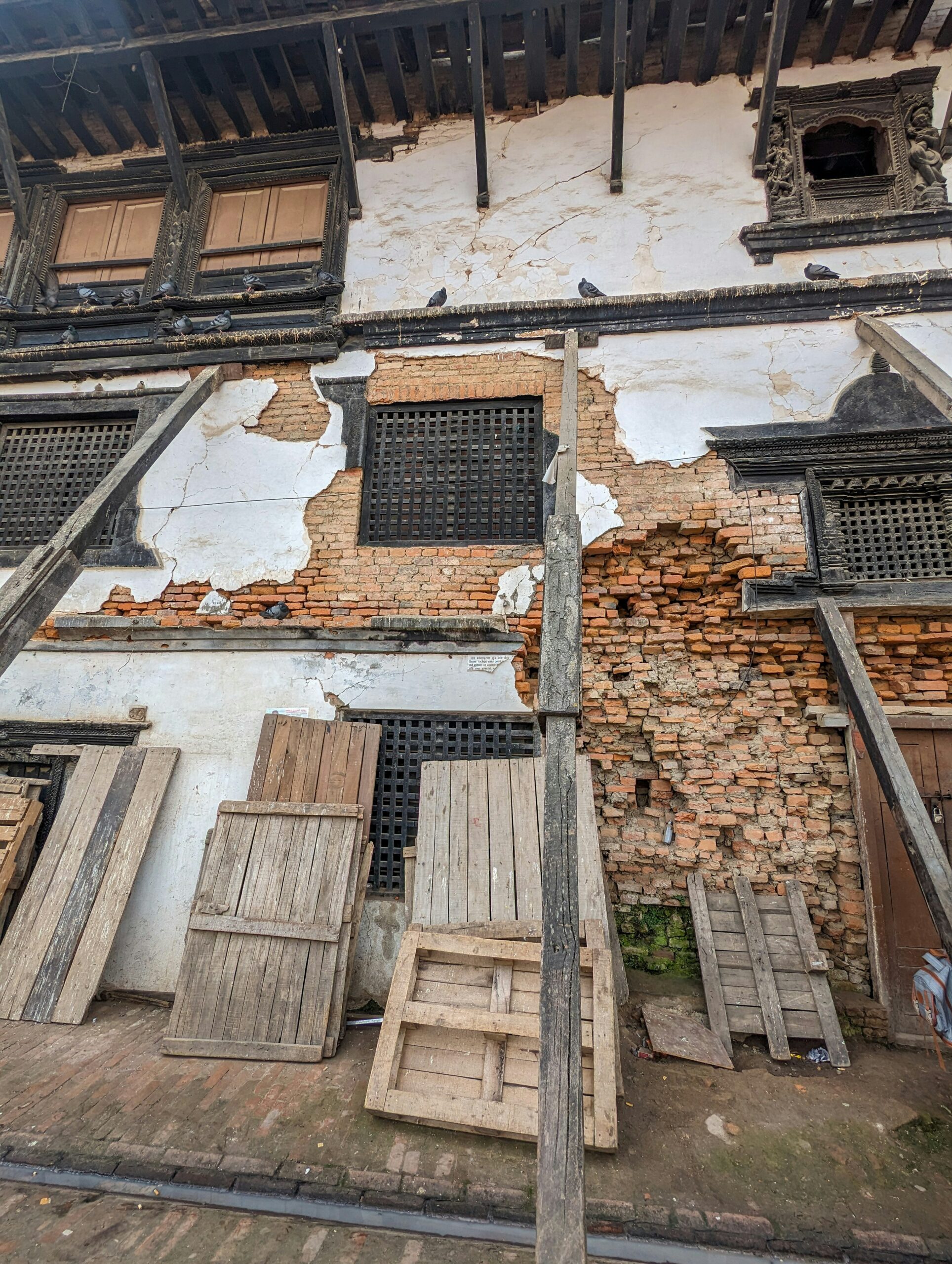 an old building with wooden doors and windows